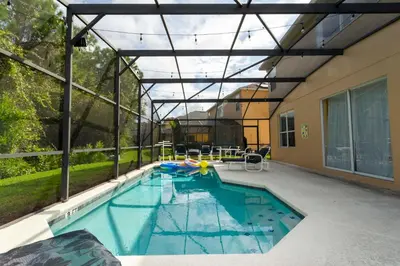an indoor swimming pool with an open roof at 7 Bedroom Mansion Near Disney in Kissimmee