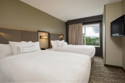 a hotel room with two beds and a television at SpringHill Suites Orlando Altamonte Springs/Maitland in Orlando