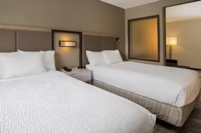two beds in a hotel room with white sheets at SpringHill Suites Orlando Altamonte Springs/Maitland in Orlando