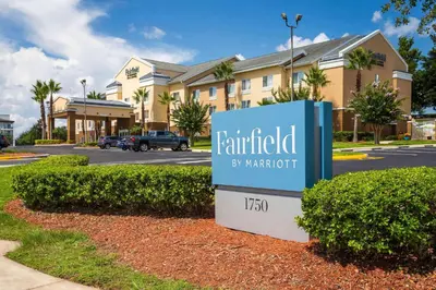 a sign for a hotel in front of a building at Fairfield Inn & Suites by Marriott Clermont in Clermont