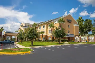 a building on a street with a parking lot at Fairfield Inn & Suites by Marriott Clermont in Clermont