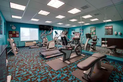 a gym with treadmills and exercise equipment in a room at Fairfield Inn & Suites by Marriott Clermont in Clermont