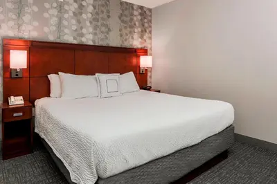 a large bed in a hotel room with two lamps at Courtyard by Marriott Orlando Lake Mary North in Lake Mary