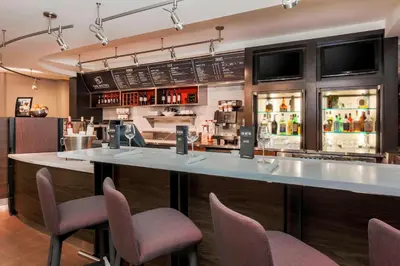a bar with chairs and a counter in a restaurant at Courtyard by Marriott Orlando Lake Mary North in Lake Mary