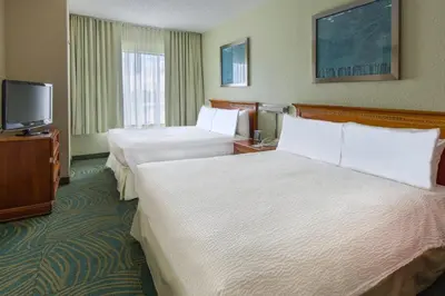 a hotel room with two beds and a flat screen tv at SpringHill Suites by Marriott Orlando North-Sanford in Sanford