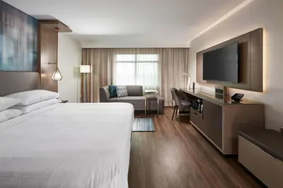 a hotel room with a bed and a flat screen tv at Orlando Marriott Lake Mary in Lake Mary