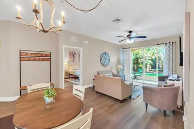 a dining room and living room with a table and chairs at Disney Bunk Room--Windsor Hills in Orlando