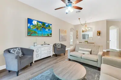 a living room with a couch and chairs and a table at Disney Bunk Room--Windsor Hills in Orlando