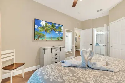 a bedroom with a bed with two swans on it at Disney Bunk Room--Windsor Hills in Orlando
