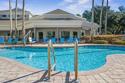 a swimming pool in front of a house at Lake Buenavista Apartments close to Disney in Orlando