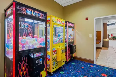 two arcade games are lined up in a room at Lake Buenavista Apartments close to Disney in Orlando