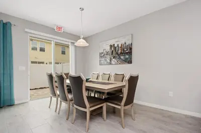 a dining room with a table and chairs at Four Bedrooms Townhome 5108K in Kissimmee