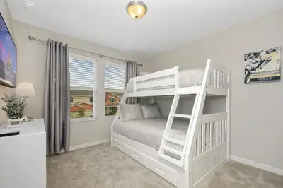 a white bedroom with a bunk bed and a ladder at Four Bedrooms Townhome 5108K in Kissimmee