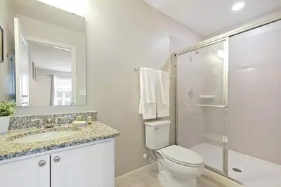 a bathroom with a toilet and a sink and a shower at Four Bedrooms Townhome 5108K in Kissimmee