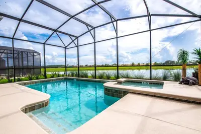 a swimming pool in a glass house with a swimming poolvisor at King Castle Circle Villa #237082 in Kissimmee
