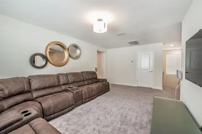 a living room with a brown couch and mirrors at King Castle Circle Villa #237082 in Kissimmee