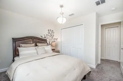 a bedroom with a large bed with white walls at King Castle Circle Villa #237082 in Kissimmee