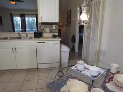 a kitchen with a glass table with dishes on it at 3 Bedroom Standard Davenport Home FL 33897 in Orlando