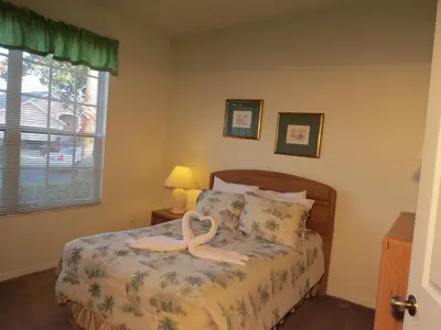a bedroom with a bed with a swan on it at 3 Bedroom Standard Davenport Home FL 33897 in Orlando