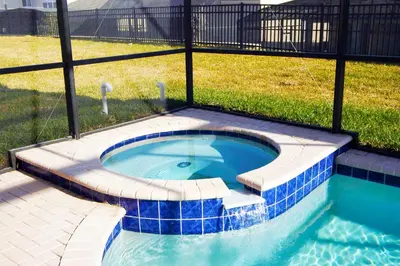 a small swimming pool with blue tiles in a yard at Windsor Hills Resort - Enchanted Crystal Castle in Orlando