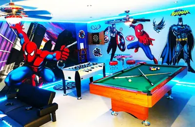 a room with a pool table and superheroes on the wall at Windsor Hills Resort - Enchanted Crystal Castle in Orlando