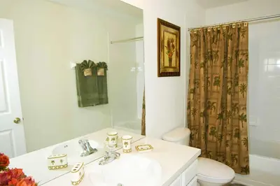 a bathroom with a sink and a toilet and a shower at Windsor Hills Resort - Enchanted Crystal Castle in Orlando