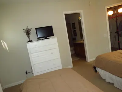 a bedroom with a dresser with a tv on top of it at Formosa Garden Pool Home in Kissimmee