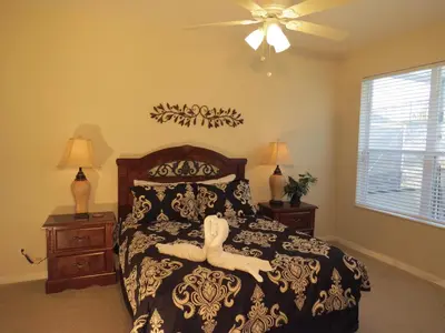 a bedroom with a bed with a person laying on it at Formosa Garden Pool Home in Kissimmee