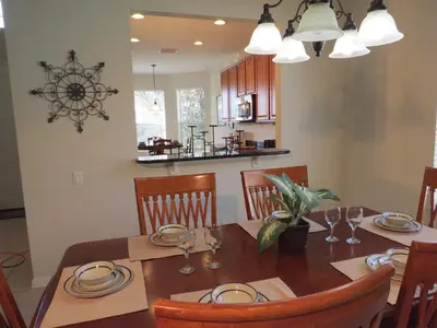 a kitchen and dining room with a table and chairs at Formosa Garden Pool Home in Kissimmee