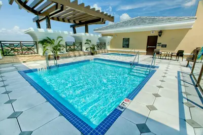 a swimming pool in the middle of a house at Plaza Suites On International Drive Near Universal Epic in Orlando