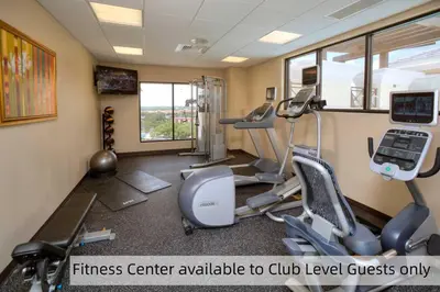 a fitness center with cardio equipment in a gym at Plaza Suites On International Drive Near Universal Epic in Orlando
