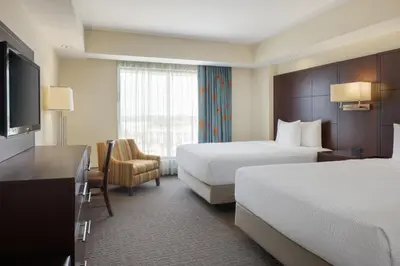 a hotel room with two beds and a television at Plaza Suites On International Drive Near Universal Epic in Orlando