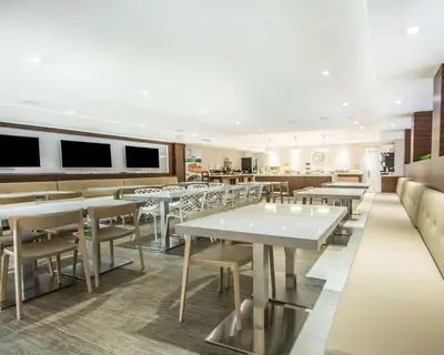 a restaurant with tables and chairs in a room at Quality Inn & Suites By the Parks in Orlando