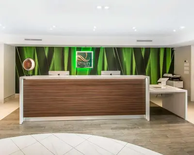 a lobby with green curtains and a reception desk at Quality Inn & Suites By the Parks in Orlando