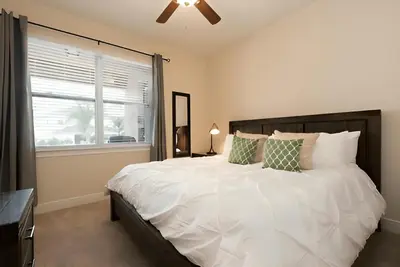 a bedroom with a large white bed and a window at Wilmington Loop 6 Br Luxury Villa with Pool and Spa in Orlando