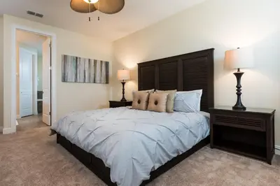 a bedroom with a large bed and two lamps at Wilmington Loop 6 Br Luxury Villa with Pool and Spa in Orlando