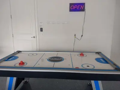 a ping pong table in a room with a sign at Wilmington Loop 6 Br Luxury Villa with Pool and Spa in Orlando