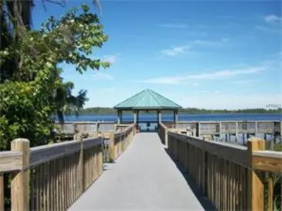 a boardwalk leading to a gazebo on the water at Penthouse Blue Heron Condo in Orlando