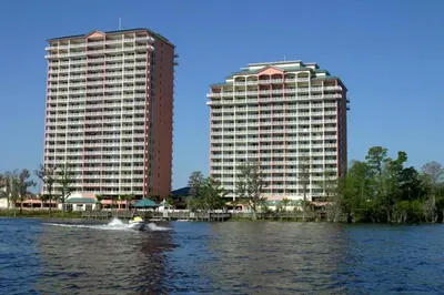 two tall buildings and a boat in the water at Penthouse Blue Heron Condo in Orlando