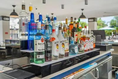 a row of bottles of alcohol on a counter at Vero`s Gem Condo in Orlando