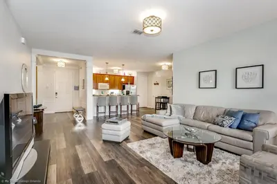 a living room with a couch and a table at Miranda's Gem Condo in Orlando
