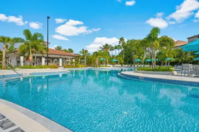 a swimming pool at a resort with palm trees at Casa Maria Condo in Orlando