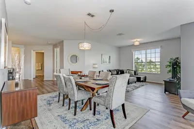 a dining room and living room with a table and chairs at Casa Maria Condo in Orlando