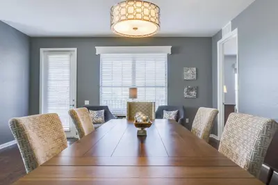 a dining room with a wooden table and chairs at Casa Maria Condo in Orlando