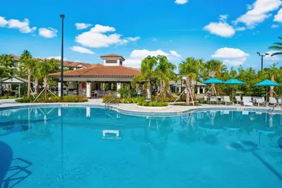 a large pool at a resort with chairs and umbrellas at Spring Lakeview Condo in Orlando