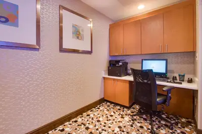 an office with a desk with a computer and a chair at SpringHill Suites by Marriott Orlando Lake Buena Vista South in Kissimmee