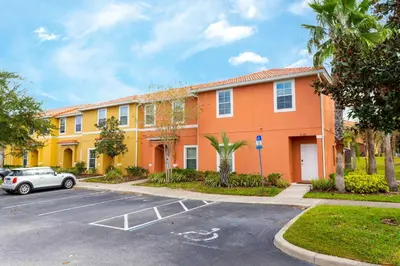 a car parked in a parking lot in front of a building at Three Bedrooms Townhome 3012 in Kissimmee