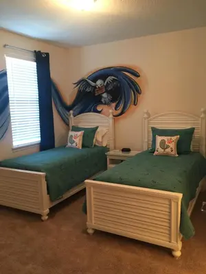 a bedroom with two beds with a painting on the wall at DREAM HOUSE, ECOLAB Sanitzed NEAR DISNEY, POOL FENCE in Orlando
