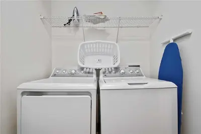 a kitchen with a stove and a basket on the wall at DREAM HOUSE, ECOLAB Sanitzed NEAR DISNEY, POOL FENCE in Orlando