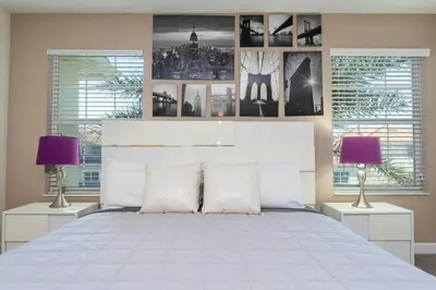 a bedroom with a large white bed with two lamps at Four Bedrooms TownHome 4861 in Kissimmee